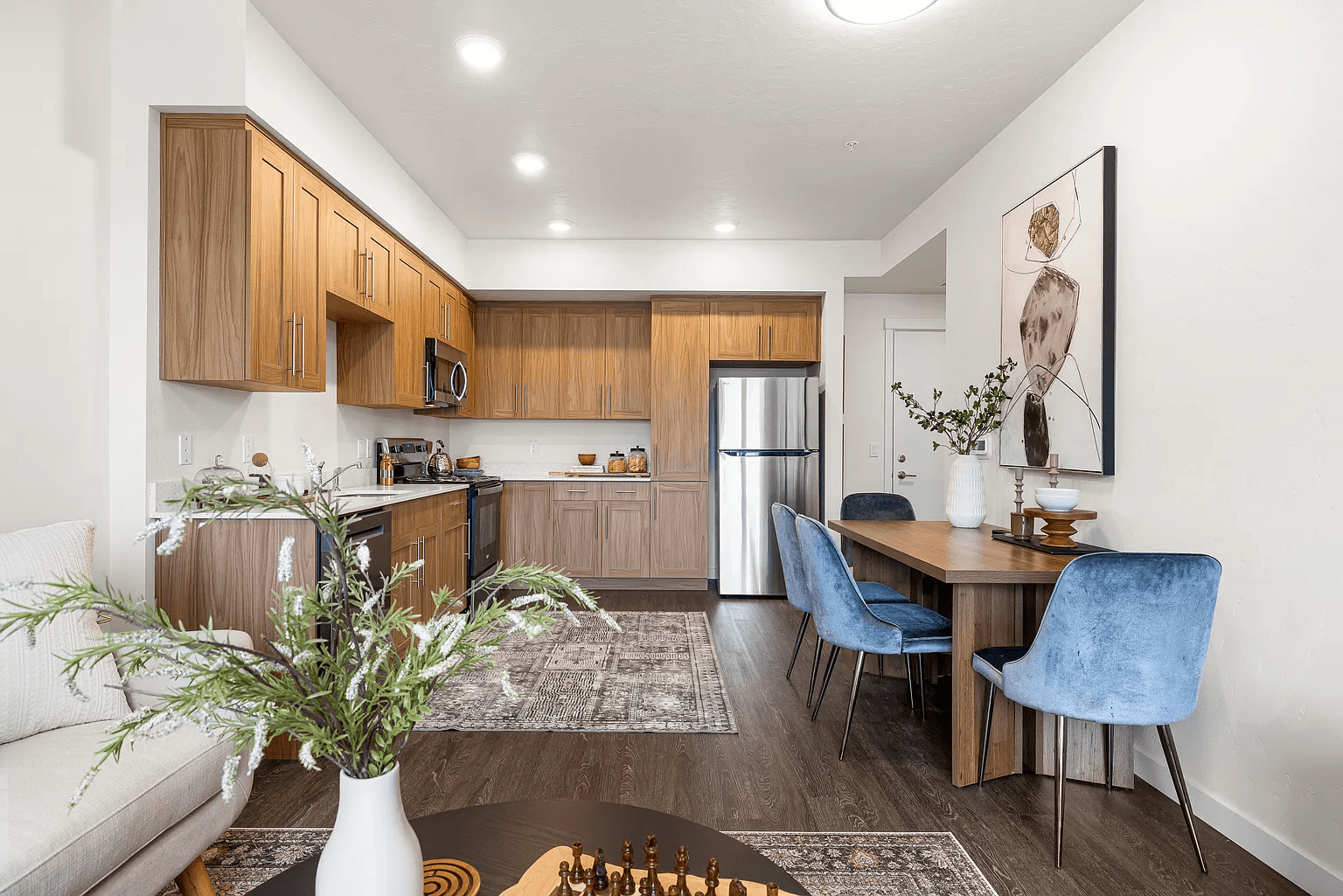 A modern kitchen with a dining table and chairs.